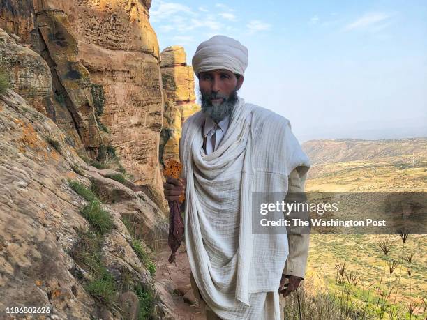 Father Assefa has climbed a 1,000-foot sheer cliff to reach the Abuna Yemata Guh church every day for 50 years.