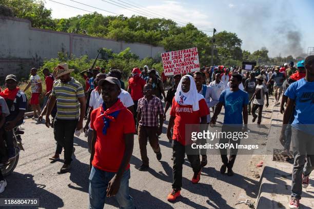 Demonstrators march toward the US Embassy during the protest. For over a year tensions has been high in Haiti, widespread governmental corruption and...