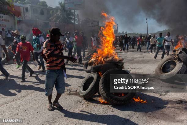 Protesters light stacks of tires and garbage on fire to serve as roadblocks along the way during the demonstration. For over a year tensions has been...