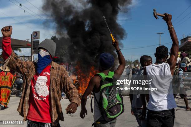 Protesters light stacks of tires and garbage on fire to serve as roadblocks along the way during the demonstration. For over a year tensions has been...