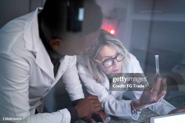 colleagues working in a laboratory - lab night stock pictures, royalty-free photos & images