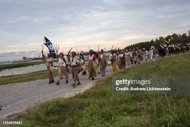 The BAPTIST PARISH, LOUISIANA In a recreation of the 1811 German Coast slave rebellion, re-enactors march the original route along the banks of the...