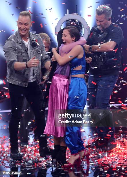 Claudia Emmanuela Santoso and Alice Merton hug each other after winning the finals of "The Voice of Germany" on November 10, 2019 in Berlin, Germany.