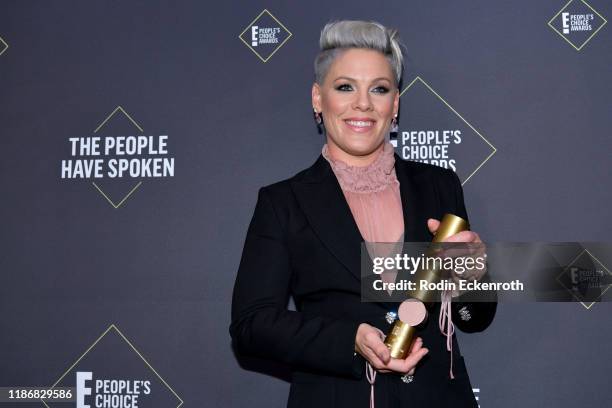 Nk, winner of People's Champion Award pose in the press room during the 2019 E! People's Choice Awards at Barker Hangar on November 10, 2019 in Santa...