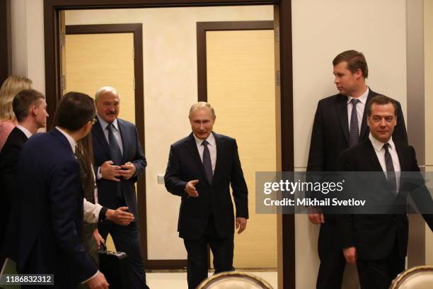 Russian President Vladimir Putin greets Belarussian President Alexander Lukashenko as Russian Prime Minister Dmitry Medvedev looks on during...