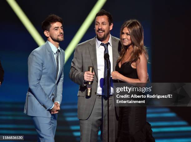 Pictured: Luis Gerardo Méndez, Adam Sandler and Jennifer Aniston accept The Comedy Movie of 2019 award for 'Murder Mystery' on stage during the 2019...
