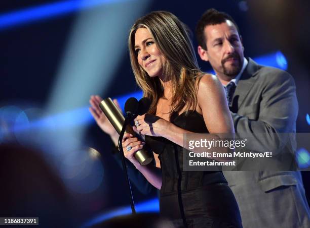 Pictured: Jennifer Aniston, winner of the People's Icon award, and Adam Sandler on stage during the 2019 E! People's Choice Awards held at the Barker...