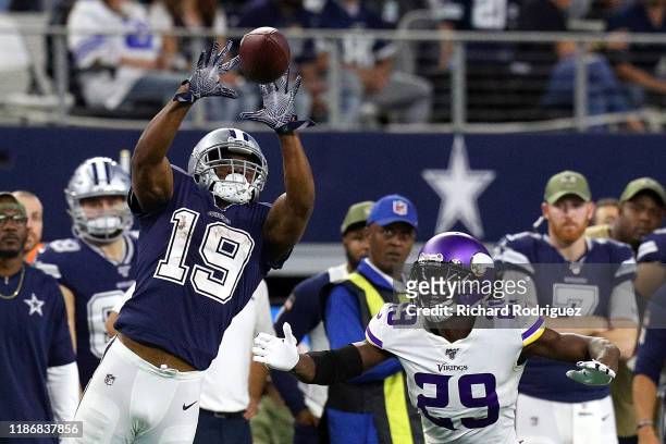 Amari Cooper of the Dallas Cowboys catches a pass over Xavier Rhodes of the Minnesota Vikings in the fourth quarter at AT&T Stadium on November 10,...