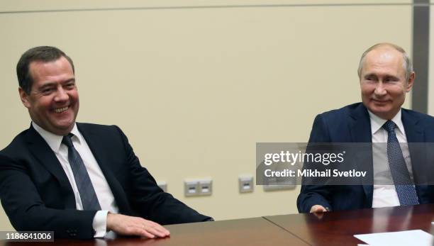 Russian President Vladimir Putin and Russian Prime Minister Dmitry Medvedev smile during Russian-Belarussian talks at Bocharov Ruchey Presidential...