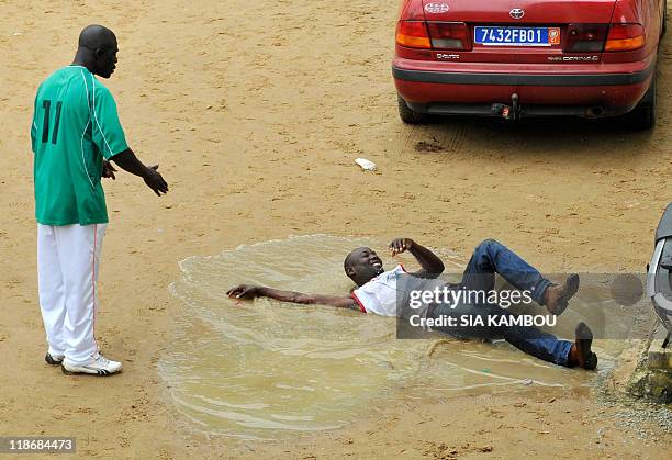 Christophe KOFFI An instrutor punishes a man as former Ivory Coast's President Laurent Gbagbo militia and Ivory Coast's President Alassane Ouattara...