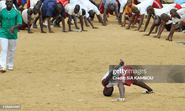 Christophe KOFFI An instrutor punishes a man as former Ivory Coast's President Laurent Gbagbo militia and Ivory Coast's President Alassane Ouattara...