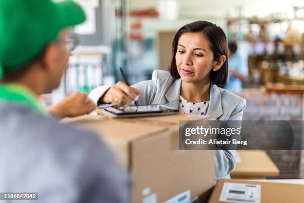 courier collecting or delivering parcels from small business - receiving stock pictures, royalty-free photos & images