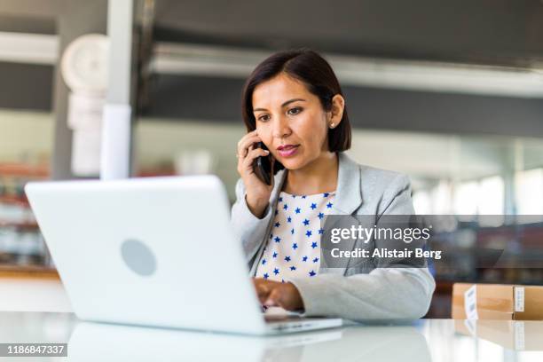 female business woman in open plan office of a small business - administrator foto e immagini stock