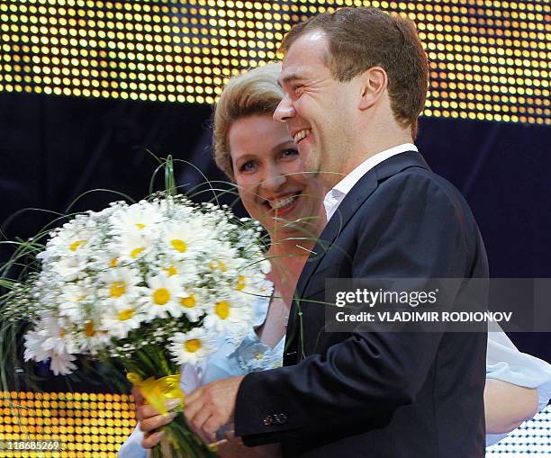 Picture taken on July 8 shows Russian President Dmitry Medvedev and his wife, Svetlana Medvedeva, smiling during the celebrations marking the Day of...