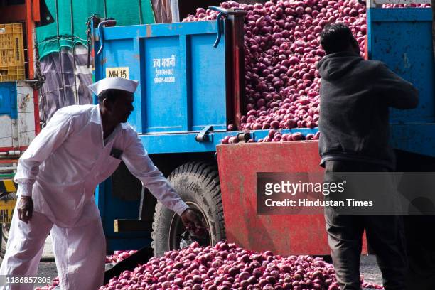 Farmer is busy in grading and separation of onions as per its quality at Lasalgaon APMC on December 5, 2019 in Nashik, India. The prices of onions...
