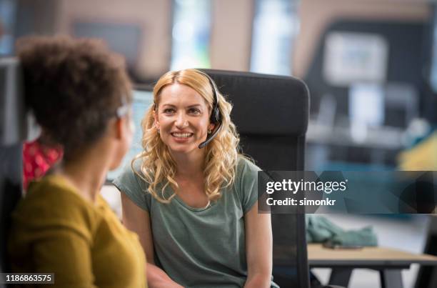 customer service representatives talking in call centre - call center team stock pictures, royalty-free photos & images