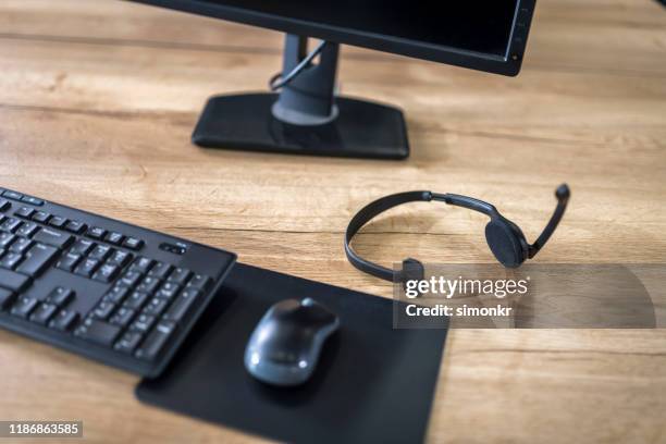 wireless headset on table - bluetooth mouse stock pictures, royalty-free photos & images