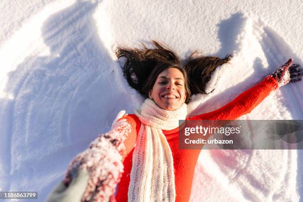 making snow angels - snow angel stock pictures, royalty-free photos & images