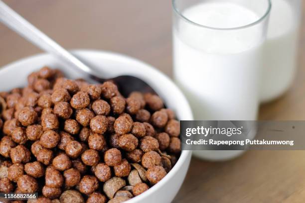 chocolate cereals in a bowl with milk - chocolate milk splash stock pictures, royalty-free photos & images