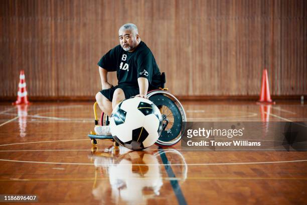 portrait of a senior wheelchair soccer player - disabilitycollection stock pictures, royalty-free photos & images