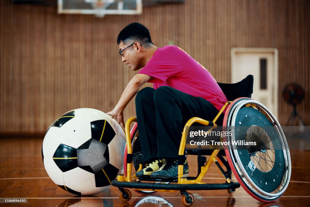 Men playing the inclusive sport of wheelchair soccer