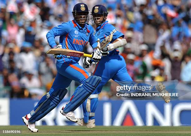 Indian cricketers Virender Sehwag and Sachin Tendulkar run between wickets during the second semi-final match of the ICC Cricket World Cup 2011...