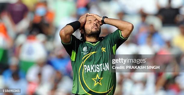 Pakistan captain Shahid Afridi reacts after dropping a catch off India batsman Sachin Tendulkar during the ICC Cricket World Cup 2011 semi-final...