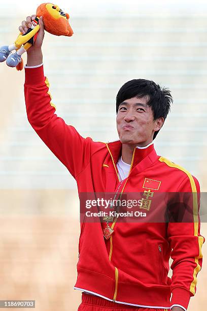 Gold medalist Liu Xiang of China poses after the Men's 110m Hurdles final during the day four of the 19th Asian Athletics Championships at Kobe...