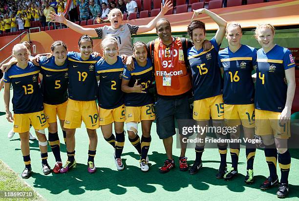 The replacement players of Australia pose with a photographer during the FIFA Women's World Cup 2011 Quarter Final match between Sweden and Australia...