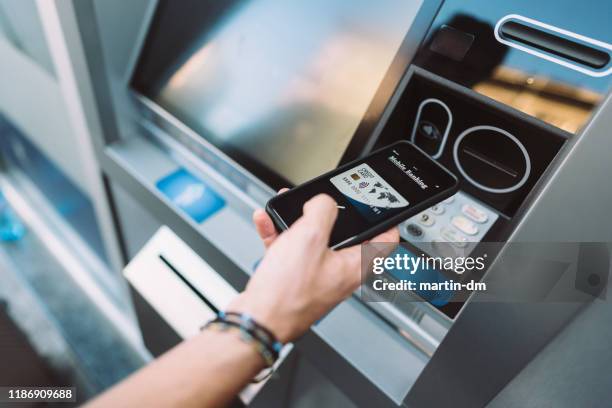 man withdrawing money using digital wallet - biometrics stock pictures, royalty-free photos & images