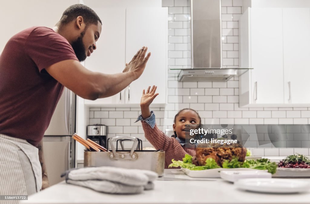African-american father and daughter preparing Thanksgiving dinner