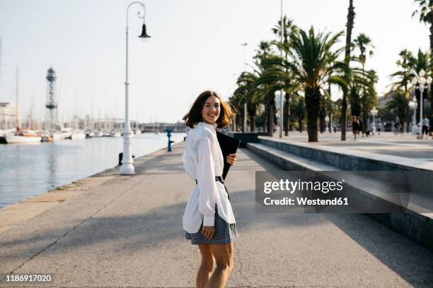 pretty businesswoman walking in the city after work - promenade seafront stock pictures, royalty-free photos & images
