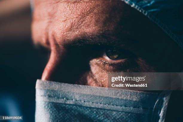 close-up of a focused surgeon - surgical mask man stock pictures, royalty-free photos & images
