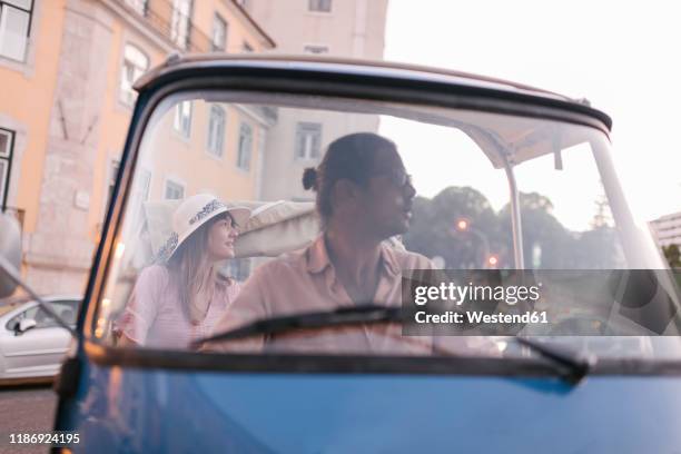 tuk tuk driver providing tour of the city to a tourist, lisbon, portugal - great customer service stock pictures, royalty-free photos & images