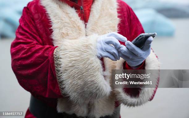 santa claus using smartphone - white glove phone stock pictures, royalty-free photos & images