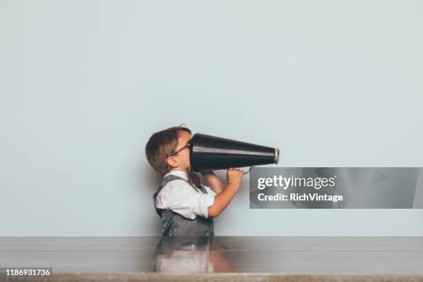young nerd boy with megaphone - communication problems stock pictures, royalty-free photos & images
