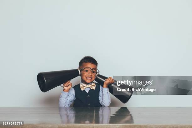 young nerd boy listening with megaphones - listening skills stock pictures, royalty-free photos & images