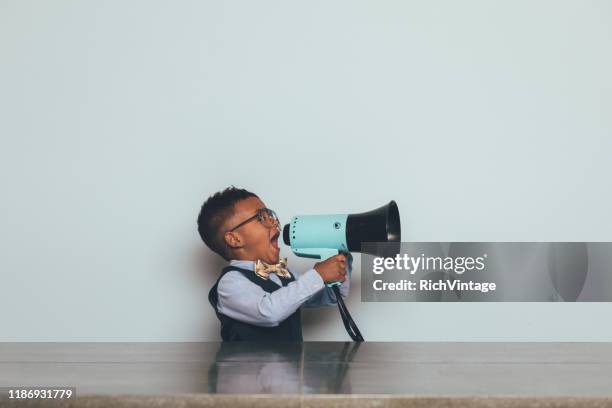 young nerd boy with megaphone - nerd fun stock pictures, royalty-free photos & images