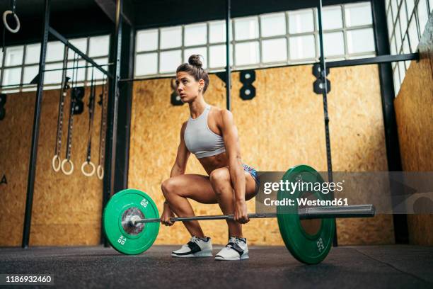 young woman doing overhead squat exercise at gym - weightlifting room stock pictures, royalty-free photos & images