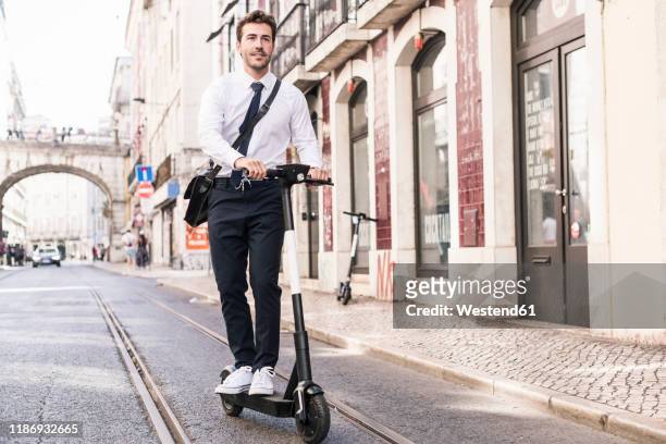 young businessman riding e-scooter in the city, lissabon, portugal - man with scooter bildbanksfoton och bilder
