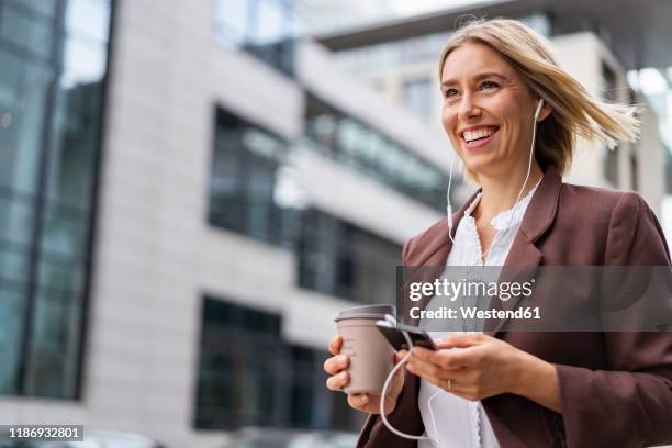 happy young businesswoman in the city on the go - leisure work coffee happy stockfoto's en -beelden