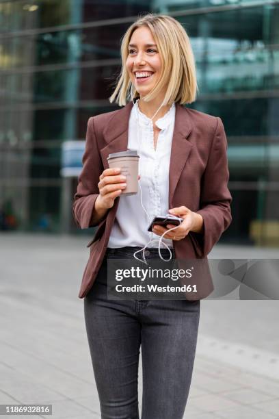 happy young businesswoman in the city on the go - leisure work coffee happy stockfoto's en -beelden