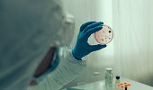 Scientist examining virus in petri dish in a laboratory