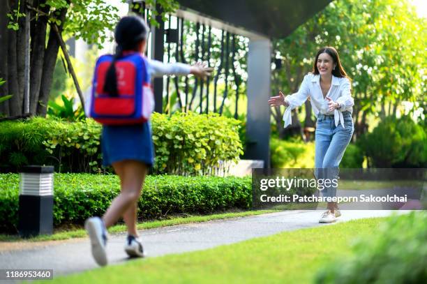 mother happy and waiting daughter in front house - nursery night stock pictures, royalty-free photos & images