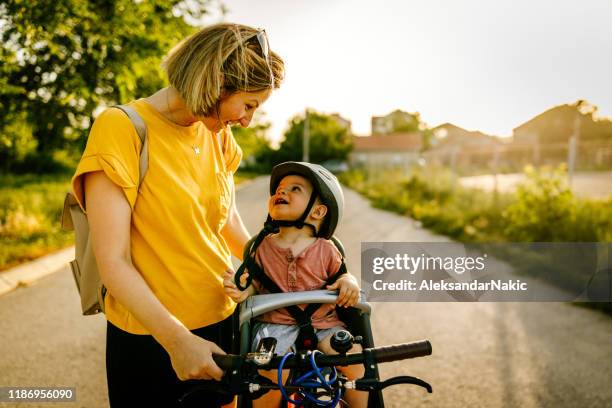 baby enjoys bicycle ride with his mom - one and a half summer stock pictures, royalty-free photos & images