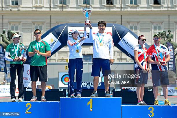 South Korean archers hold the trophy as they celebrate on the podium after winning the Archery World Championships Recurve Mixed Team event over...