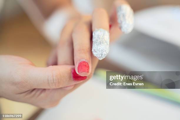 removing nail polish from hand fingers with foil, damaging nails - absence stock pictures, royalty-free photos & images