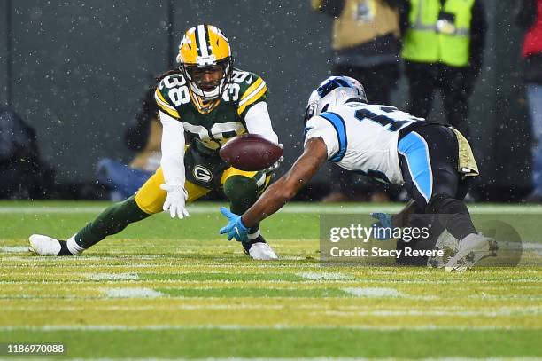 Tramon Williams of the Green Bay Packers intercepts a pass intended for Jarius Wright of the Carolina Panthers during a game at Lambeau Field on...