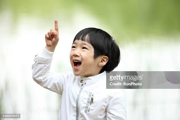 image of child,pointing at the sky, laughing boy - child pointing stock pictures, royalty-free photos & images