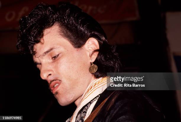 American Rock and R&B musician Willy DeVille plays guitar as he performs onstage at the Lone Star Cafe nightclub, New York, New York, May 1988.